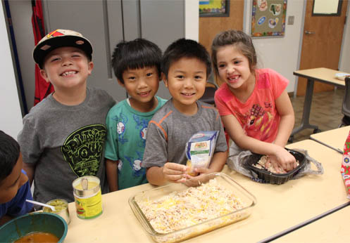 A group of kids in a cooking class.