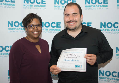 Student and teacher taking an award photo together.