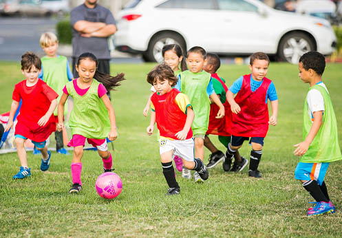 A group of kids playing soccer