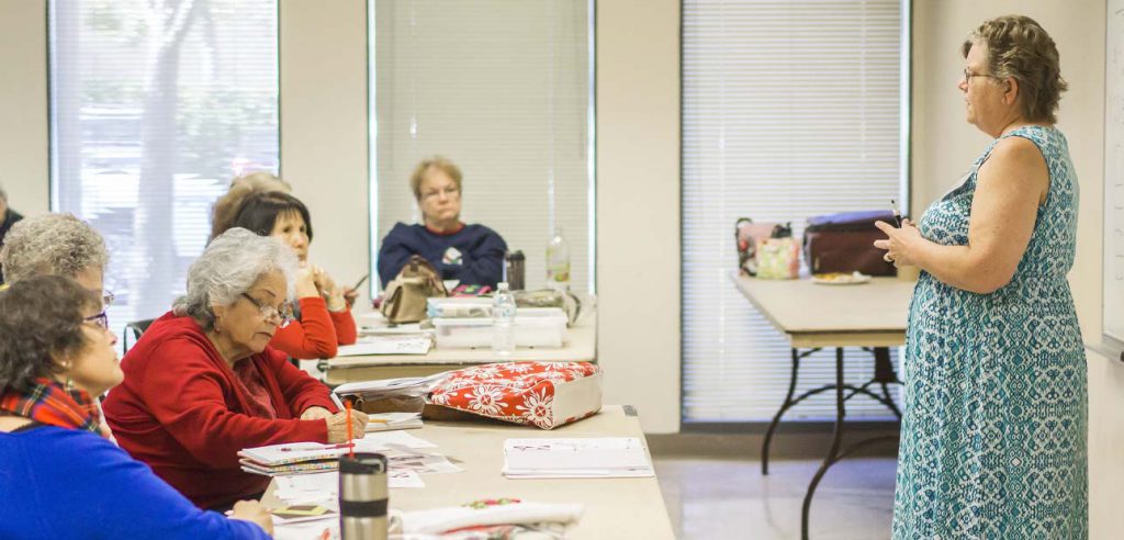 students paying attention to their instructor in class.