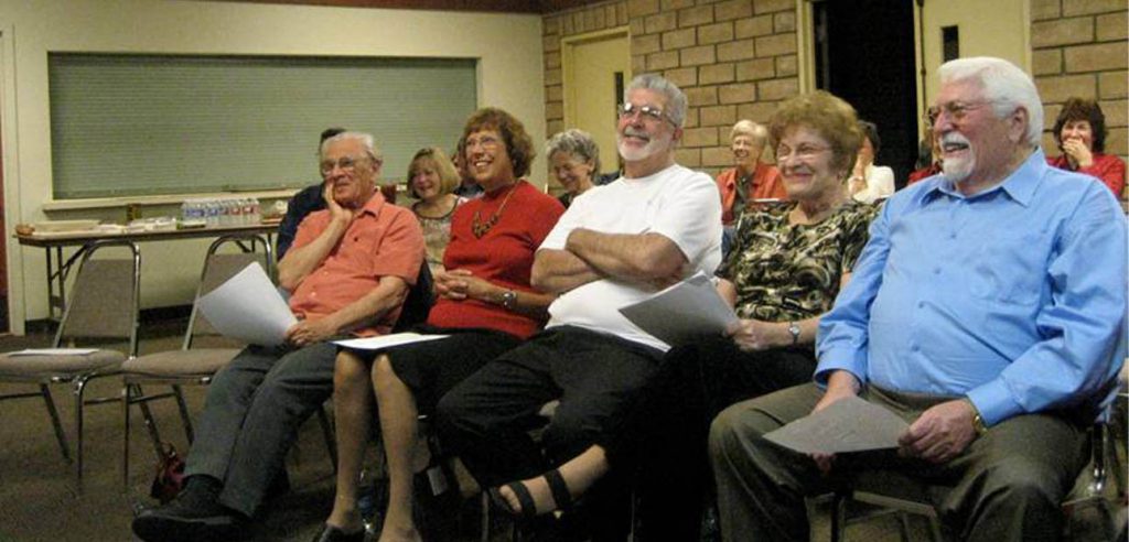 A group photo of the older adult students in class