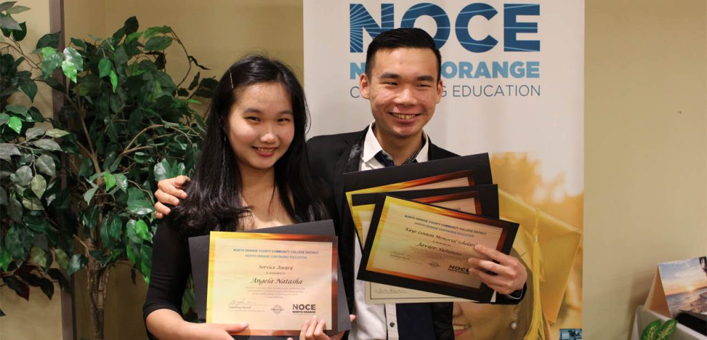 Two of the 2018 NOCE Scholarship Award winners, posing for a photo with their awards.