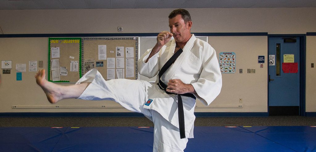 A photo of the NOCE karate instructor performing a kick. 