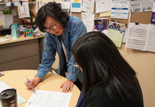 A photo of a NOCE counselor helping a student at a counseling appointment