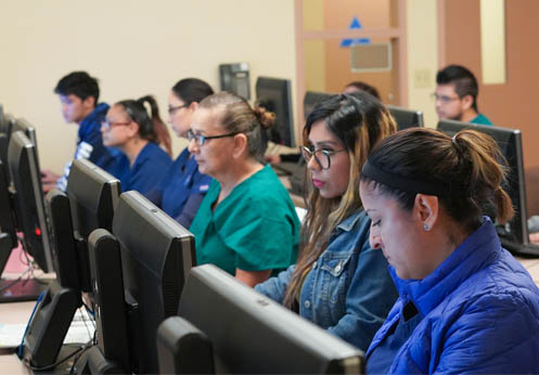 A row of CTE students at their computers.