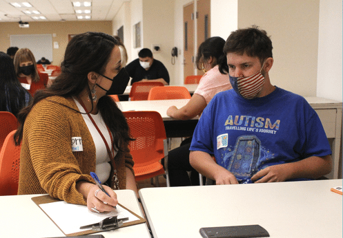 A female DSS counselor speaking to a DSS male student